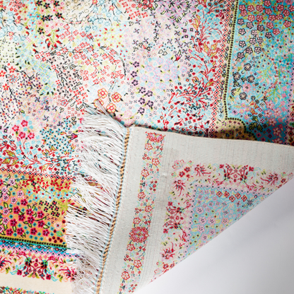 Gohan Silk Rug with intricate floral detailing in red, blue, and pastel tones on an ivory base with turquoise borders, 150x100 cm.