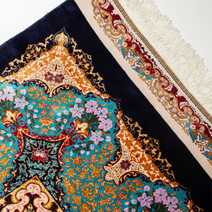 Ilse Silk Rug in 200x300 cm featuring a navy base, turquoise medallion, and intricate floral motifs.