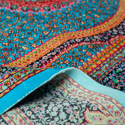 Jaze Silk Rug featuring a central floral medallion on a turquoise base with red, green, and black detailing, size 150x100 cm.