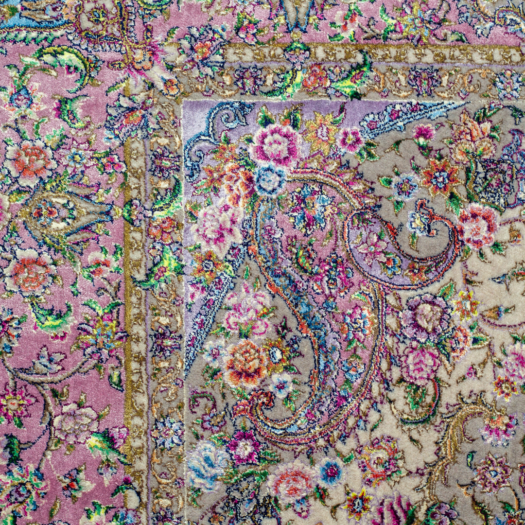 The Kale silk rug features a pink and beige floral medallion design, handwoven in fine silk with intricate detailing.