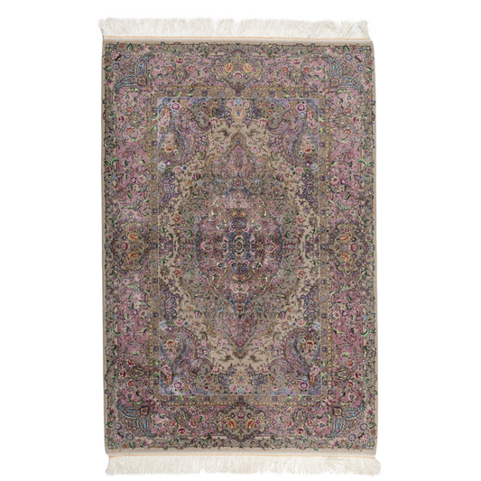 The Kale silk rug features a pink and beige floral medallion design, handwoven in fine silk with intricate detailing.