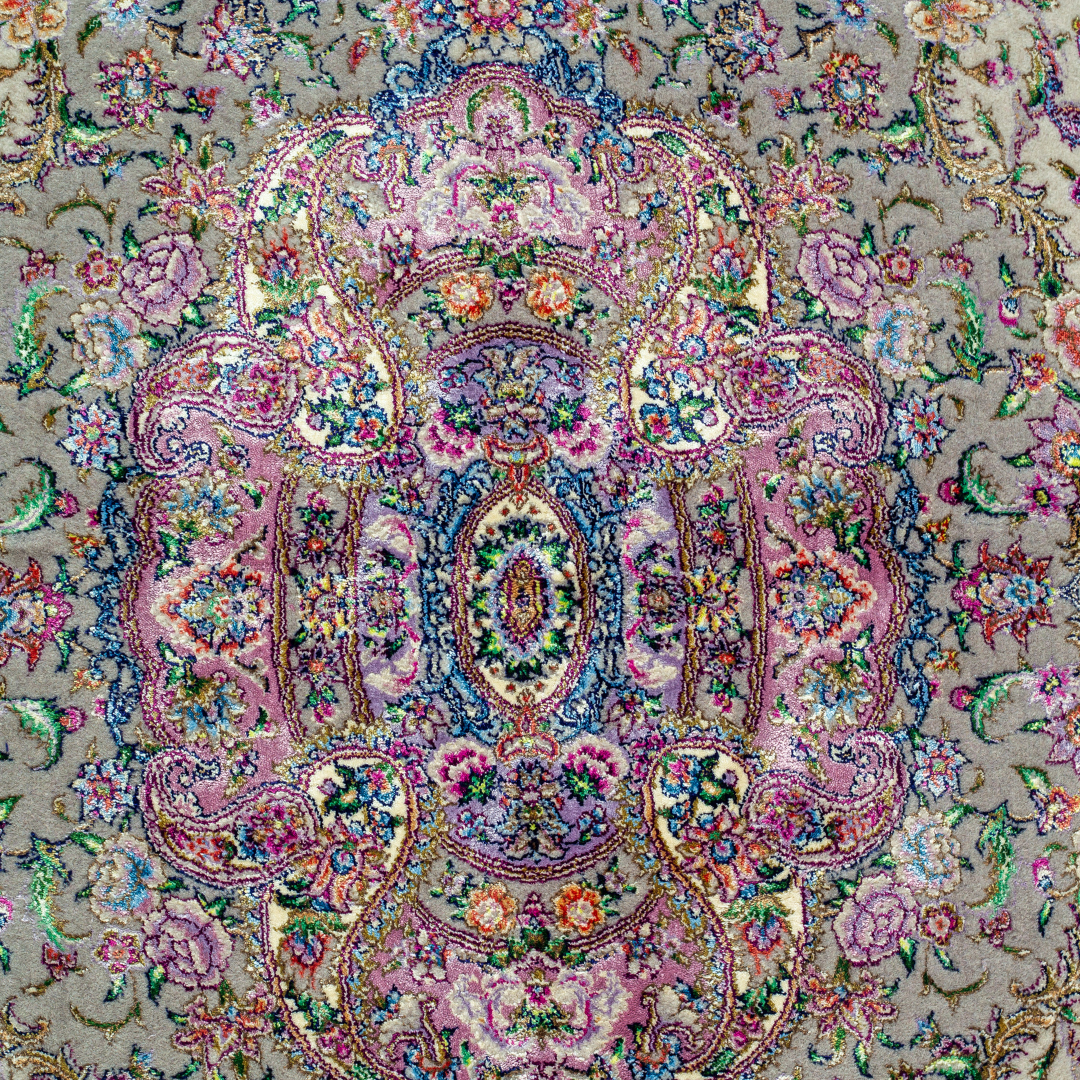 The Kale silk rug features a pink and beige floral medallion design, handwoven in fine silk with intricate detailing.