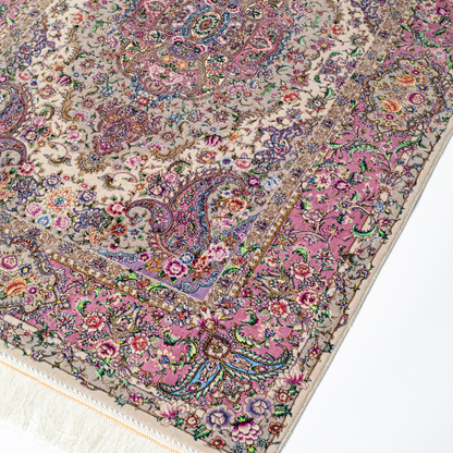 The Kale silk rug features a pink and beige floral medallion design, handwoven in fine silk with intricate detailing.