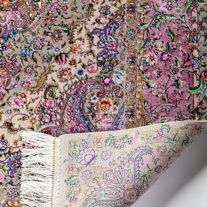 The Kale silk rug features a pink and beige floral medallion design, handwoven in fine silk with intricate detailing.