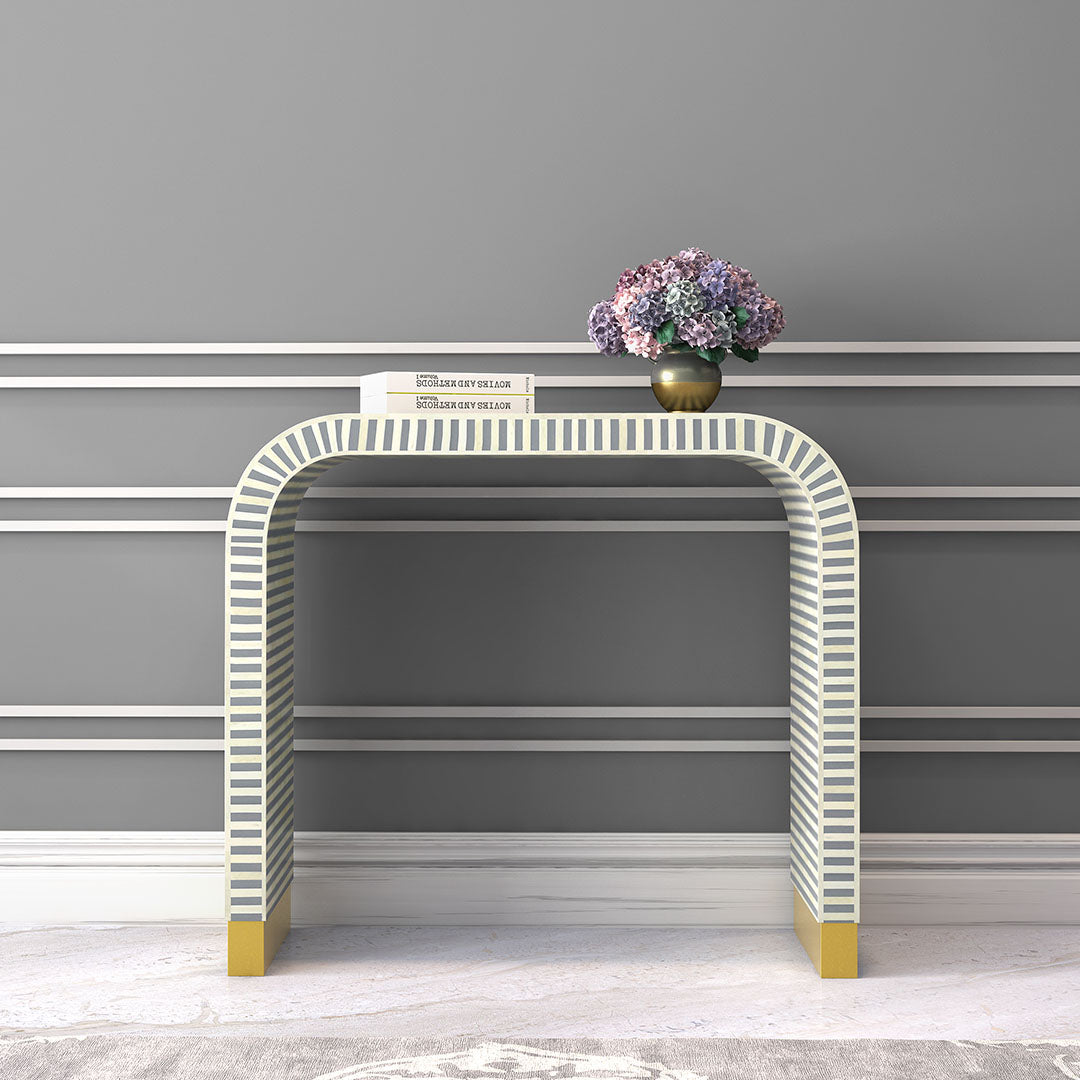 Elegant Lume Console in grey bone inlay with arched design and gold base, adding sophistication to entryways and living spaces.
