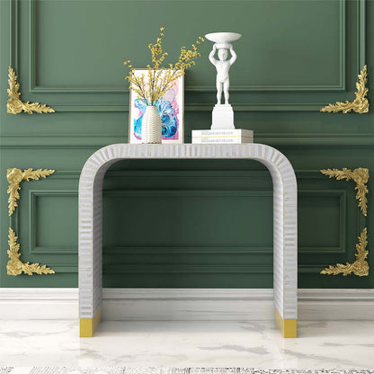 Elegant white bone inlay console with intricate detailing and a modern curved silhouette.