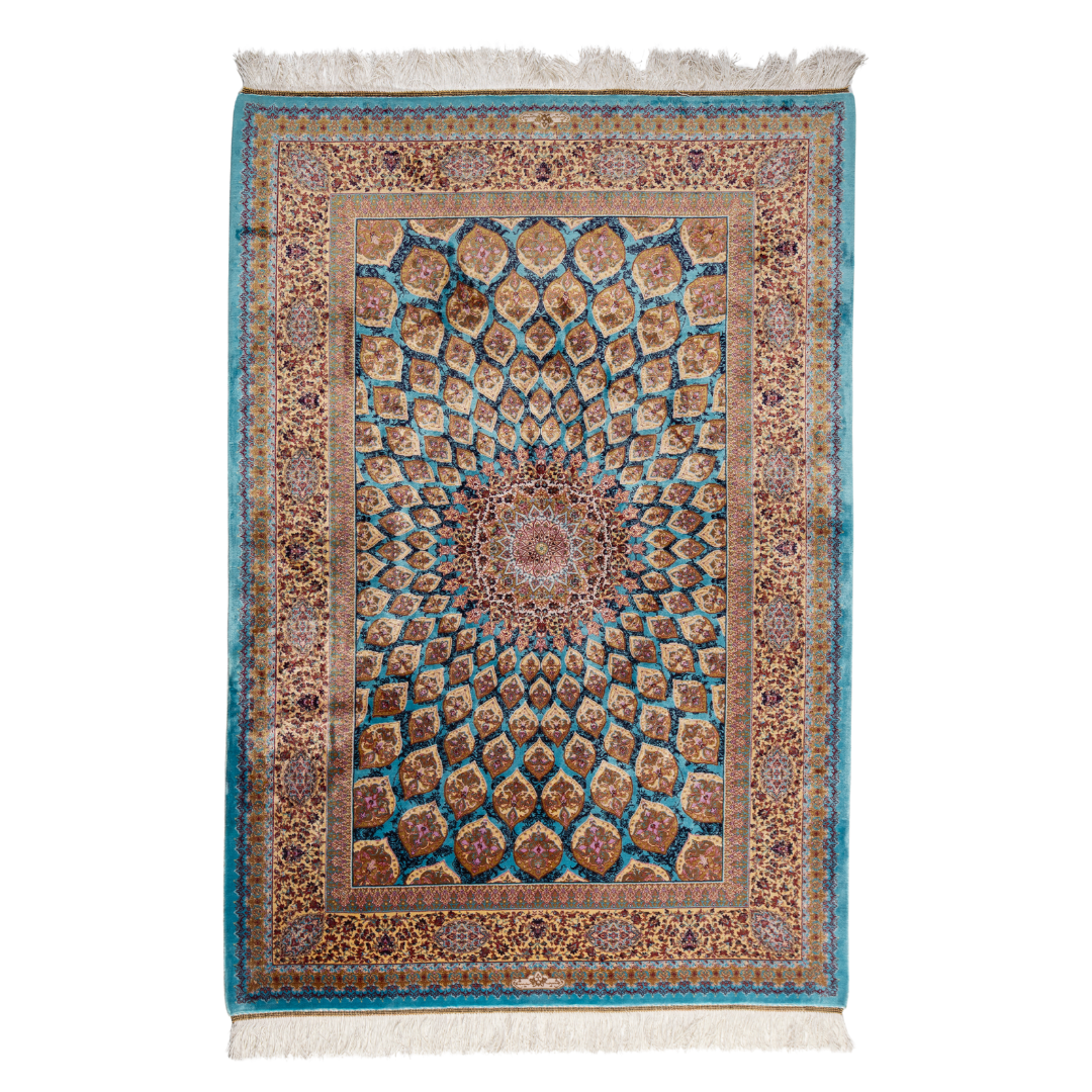 Maki silk rug featuring a turquoise blue base with intricate gold, ruby red, ivory, and fuchsia floral medallion design in a symmetrical pattern.

