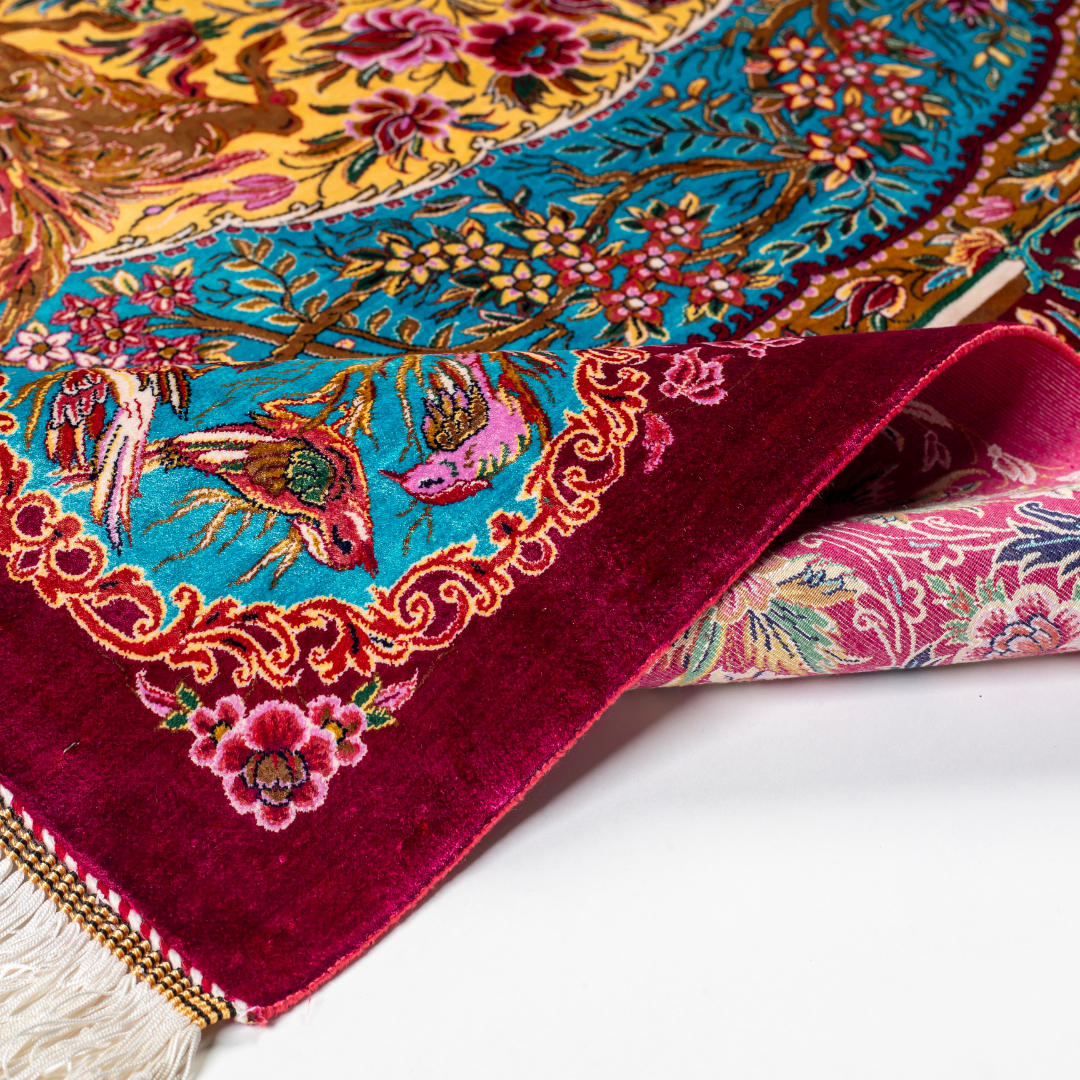 Opulent silk rug with ruby base and turquoise floral accents. Detailed handwoven artistry ideal for luxury, dramatic interior settings.

