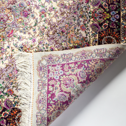 Miren silk rug in ivory and purple with intricate floral design, handwoven with fine craftsmanship and premium detailing.
