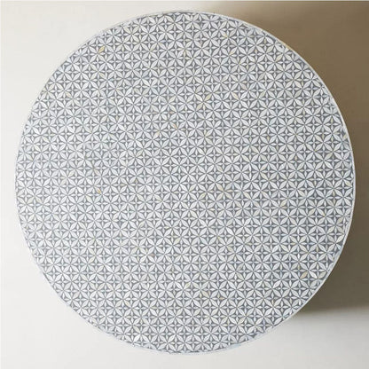 Round grey bone inlay coffee table with floral design and a bold gold base. A stylish and modern centerpiece for any living room.