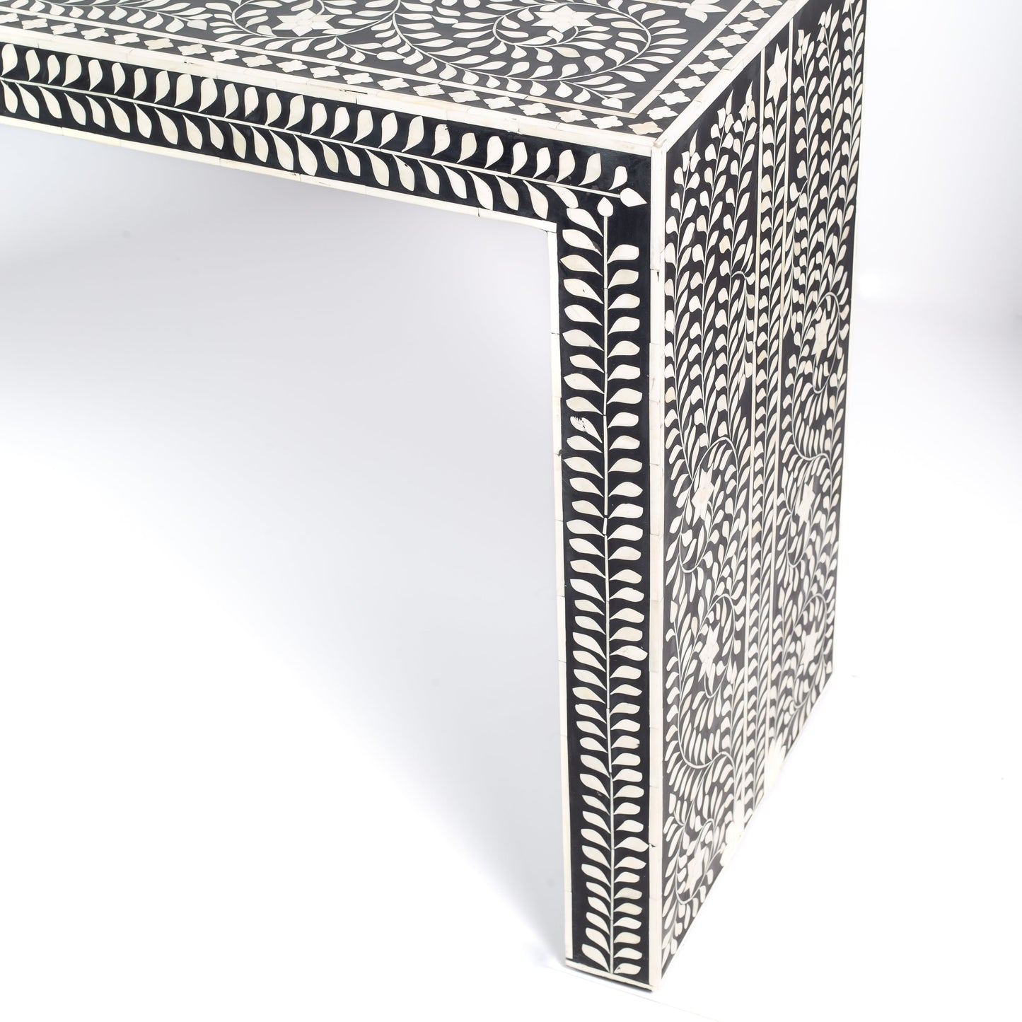 Black bone inlay console table with floral and vine motifs, handcrafted by artisans and finished with intricate detailing across the surface.