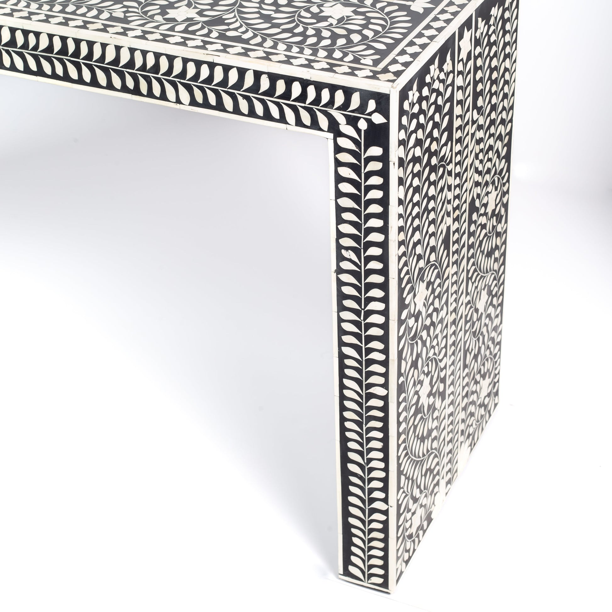 Black bone inlay console table with floral and vine motifs, handcrafted by artisans and finished with intricate detailing across the surface.