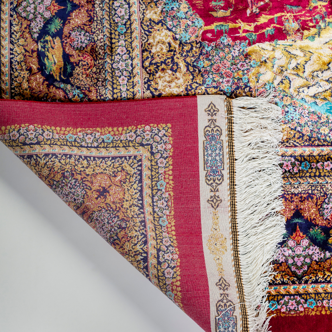 Silk rug in deep garnet red with majestic horsemen, animals, and ornate border work. Handwoven art that brings dynamic motion to interiors.

