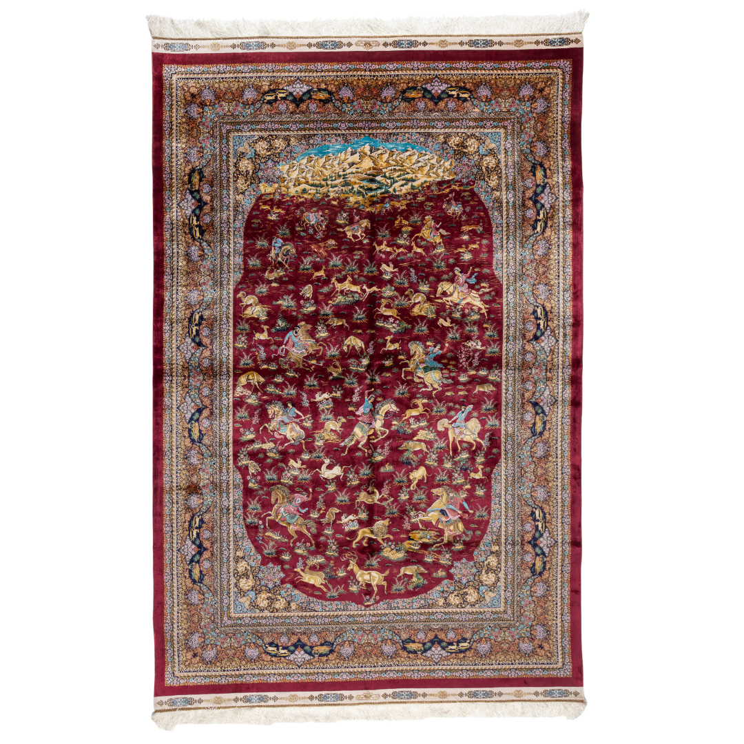 Silk rug in deep garnet red with majestic horsemen, animals, and ornate border work. Handwoven art that brings dynamic motion to interiors.

