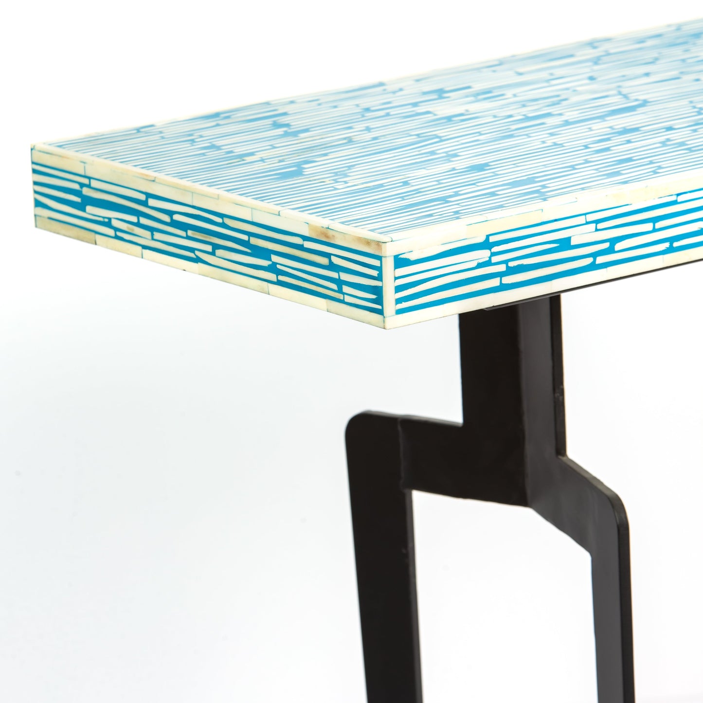 Table with a blue and white patterned top and black legs 