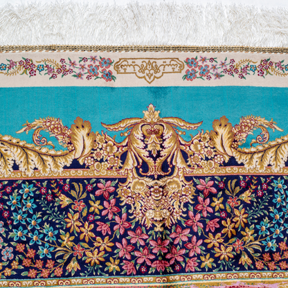 Luxurious silk rug with turquoise base, floral borders, and tree of life with colorful birds and swans.

