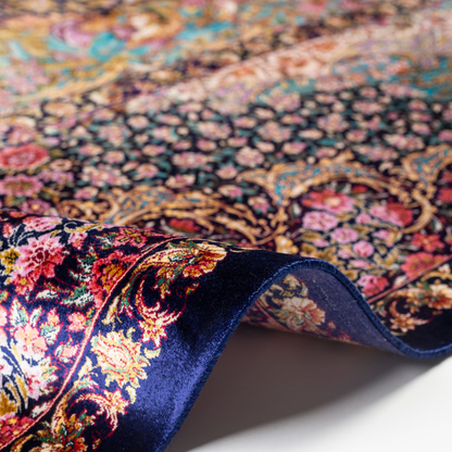 Elegant silk rug in navy, pink, gold, and turquoise with detailed-inspired floral and dancer motifs.


