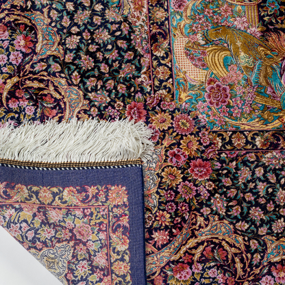 Elegant silk rug in navy, pink, gold, and turquoise with detailed-inspired floral and dancer motifs.


