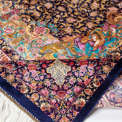 Elegant silk rug in navy, pink, gold, and turquoise with detailed-inspired floral and dancer motifs.


