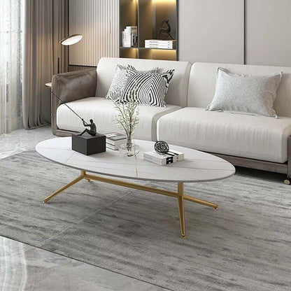 Oval white marble coffee table with subtle gold vein detailing and sleek gold legs. A modern and elegant addition to any living space.