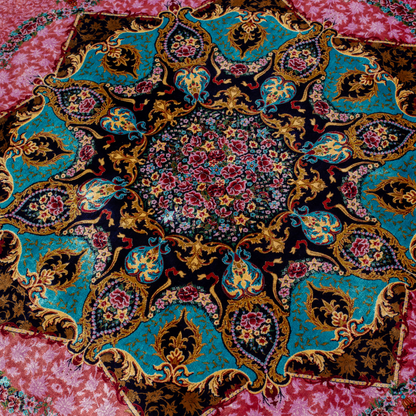 Round silk rug with a vibrant pink base, intricate navy floral borders, and detailed medallion center, 200x200 cm.
