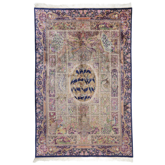 Luxurious silk rug with central bird tree, bordered by peacocks and florals. Handwoven in soft jewel tones with ornate framed details.

