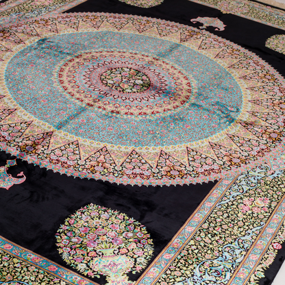 Luxurious silk rug featuring a central medallion in turquoise and pink, floral vases in corners, and ornate borders on a dark base.