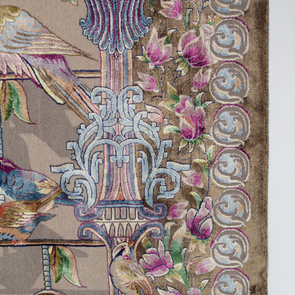 Handwoven silk rug featuring birds on a beige grid, floral corners, and classical columns. A joyful yet elegant statement piece.

