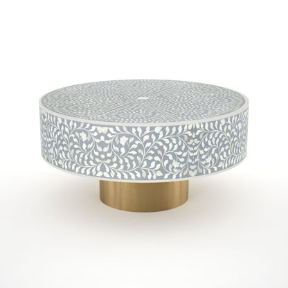 Round grey bone inlay coffee table with floral design and a gold base