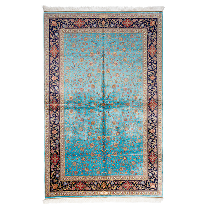 Aquamarine silk rug with coral and ivory floral motifs, framed by an indigo border. Handwoven with intricate detail and radiant sheen.

