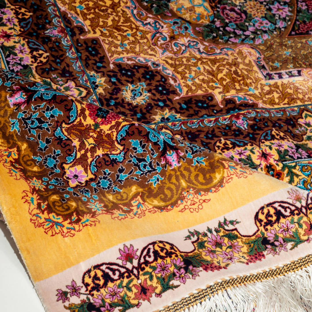 Luxurious silk rug featuring floral medallion pattern in gold, ivory, rose, and turquoise tones with intricate craftsmanship.