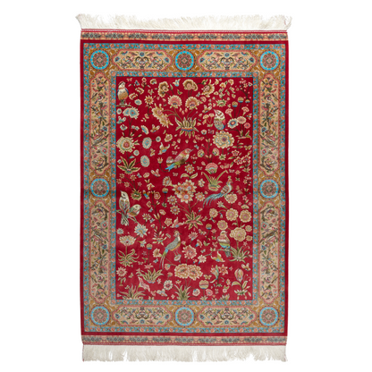 Crimson red silk rug featuring multi-colour floral and bird motifs, accented with turquoise, ivory, and gold detailing.