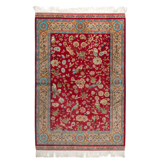 Crimson red silk rug featuring multi-colour floral and bird motifs, accented with turquoise, ivory, and gold detailing.