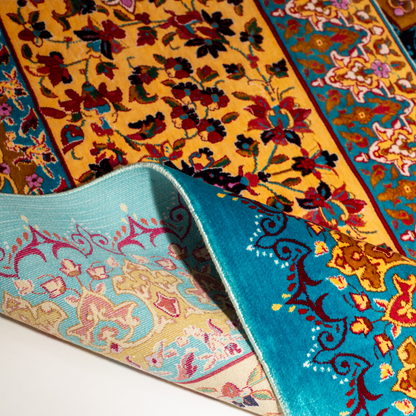 Spot silk rug in 350x250 cms featuring turquoise and mustard floral designs with a detailed medallion and golden border work.