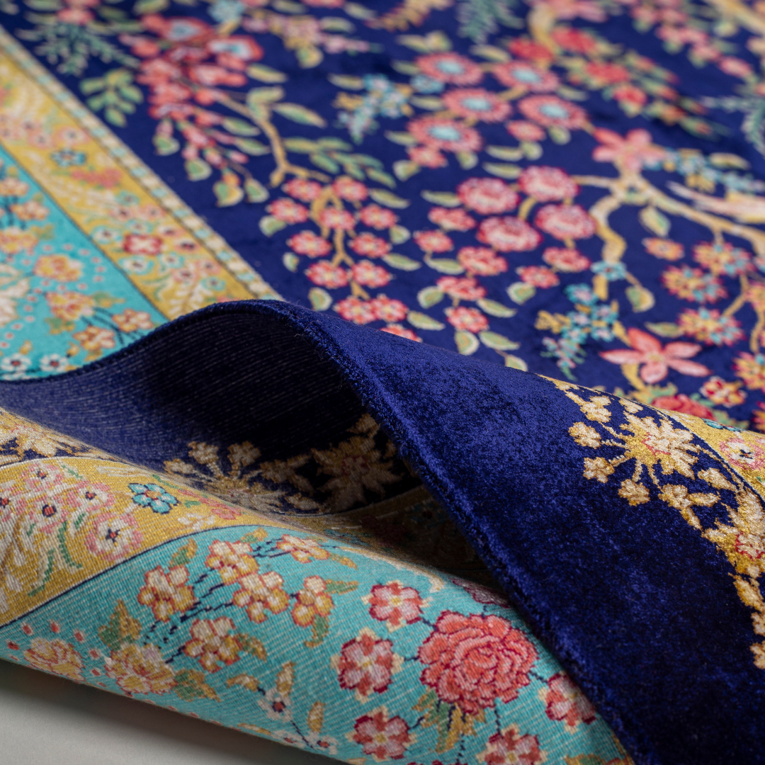 Silk rug in navy with crimson, pink, jade, and gold floral design. Tree-of-life motif. Size: 225x150 cm. Ships worldwide.