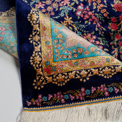 Silk rug in navy with crimson, pink, jade, and gold floral design. Tree-of-life motif. Size: 225x150 cm. Ships worldwide.