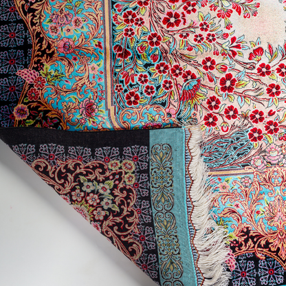 Tapin Silk Rug featuring nature-inspired artwork with birds, flowers, and flowing water on an ivory base with turquoise and black borders, 150x100 cm.