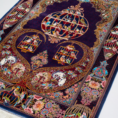 Terra silk rug with navy base, multi-colour birdcage motifs, floral accents, and detailed animal and garden scenes in 150x100 cm size.
