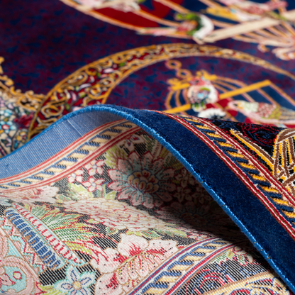 Terra silk rug with navy base, multi-colour birdcage motifs, floral accents, and detailed animal and garden scenes in 150x100 cm size.
