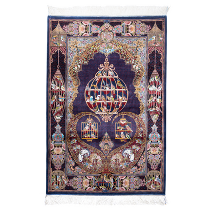 Terra silk rug with navy base, multi-colour birdcage motifs, floral accents, and detailed animal and garden scenes in 150x100 cm size.

