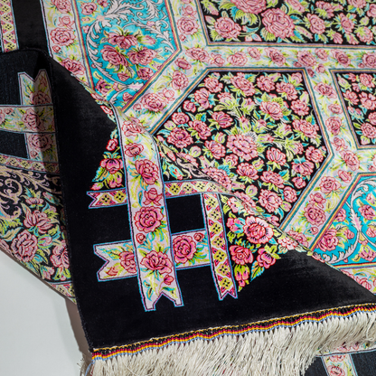 200x300 cm black silk rug with vivid pink rose motifs, turquoise borders, and central medallion. Intricate hand-knotted floral design.
