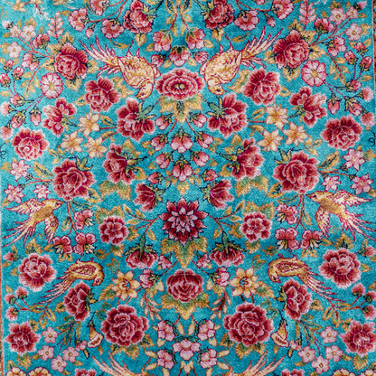 Tolly Silk Rug featuring ruby red floral and bird motifs on an aqua-blue base with golden ornate panels, size 150x100 cm.
