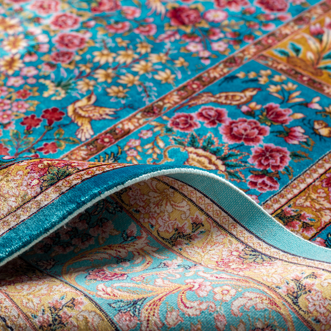 Tolly Silk Rug featuring ruby red floral and bird motifs on an aqua-blue base with golden ornate panels, size 150x100 cm.