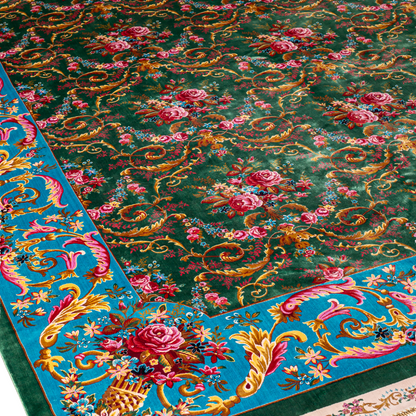 Green silk rug with detailed rose motifs and a turquoise border, featuring Persian-inspired floral designs and ornamental flourishes.