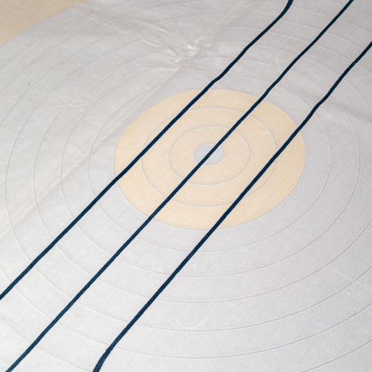 Victor cotton Rug in 200x300 cm featuring beige and ivory tones with minimal blue line and circle design, made from soft silk blend.