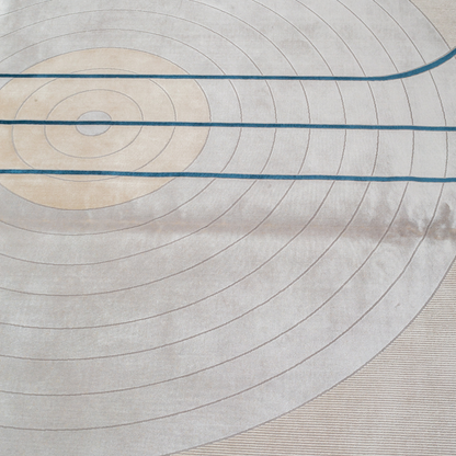 Victor cotton Rug in 200x300 cm featuring beige and ivory tones with minimal blue line and circle design, made from soft silk blend.