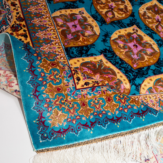 Luxurious 200x300 cm silk rug featuring a radiant blue and gold medallion design with intricate floral and geometric detailing.

