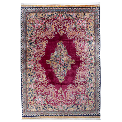 Zane Silk Rug with crimson red base, floral medallion pattern, intricate gold scrolls, and a navy border, crafted in fine silk with detailed motifs.