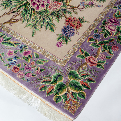 Elegant silk rug with peacock and floral design in soft pastels. Framed by intricate vine borders. A handwoven masterpiece of grace.


