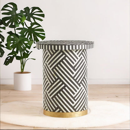 Black bone inlay side table with bold striped pattern, handcrafted with a brass base accent, ideal for modern interiors.